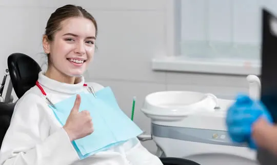 girl at orthodontist happy
